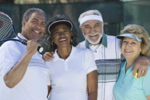 Two couples playing tennis, portrait